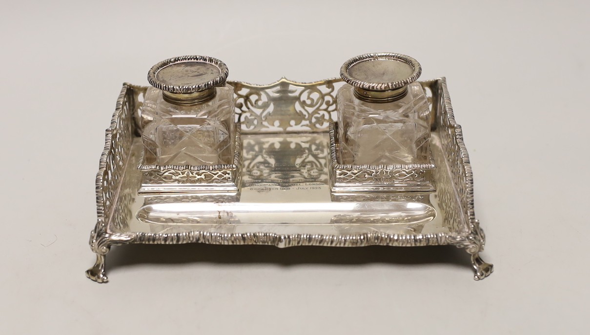 A George V pierced silver rectangular inkstand, with two mounted glass bottles and pen recess, Goldsmiths & Silversmiths Co Ltd, London, 1925, 19.5cm, 12.7oz.